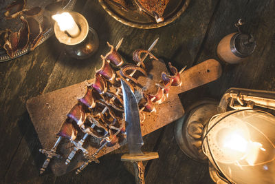 High angle view of illuminated candles on table