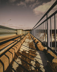 Bridge over sea against sky during sunset