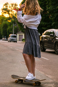 Woman with umbrella on street in city