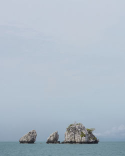 Scenic view of rock formation in sea against sky