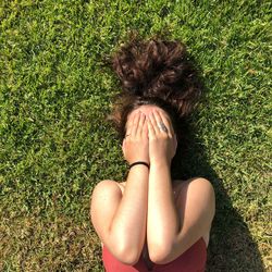 High angle view of woman lying on grass