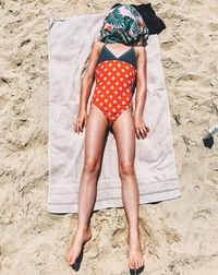 Full length of woman lying on sand