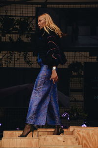 Woman standing against wall