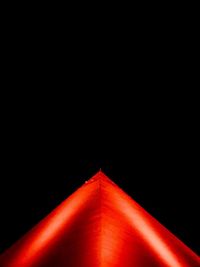 Low angle view of red light against black background