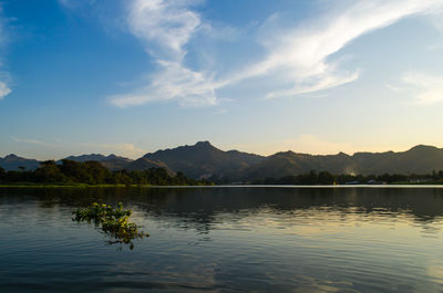 Scenic view of lake by mountains against sky