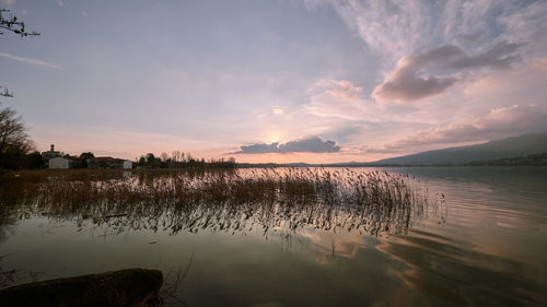 Scenic view of lake against sky during sunset