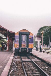 Train at railroad station against sky