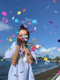 Full length portrait of girl against blue sky