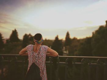 Rear view of woman looking at view during sunset