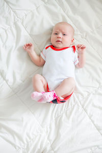 Portrait of cute baby boy sleeping on bed at home