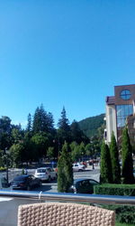 Road in city against clear blue sky