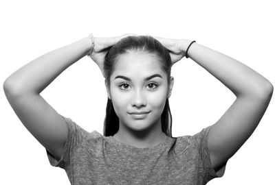 Portrait of happy young woman against white background