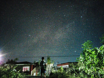 Low angle view of trees against sky at night