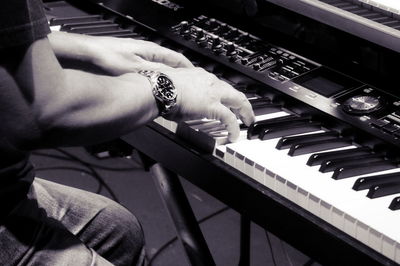 Close-up of man playing piano