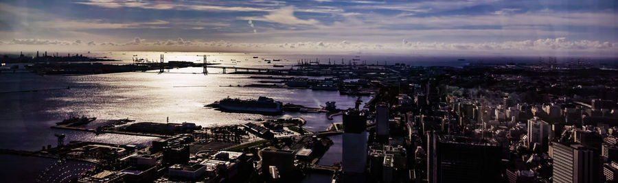 High angle view of harbor in city at sunset