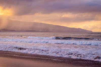 Waves in the atlantic ocean, before sunset, colorful sky, azores travel destination.