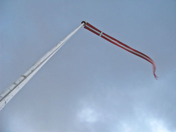 Low angle view of crane against sky