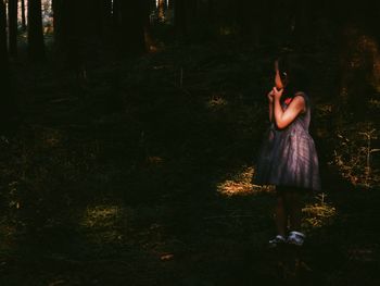 Woman standing in forest