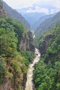 Scenic view of river amidst mountains against sky