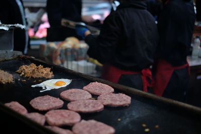 High angle view of fresh meat and egg on stove at concession stand