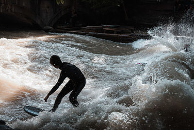 Man splashing water in sea