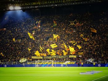 Group of people on soccer field at night