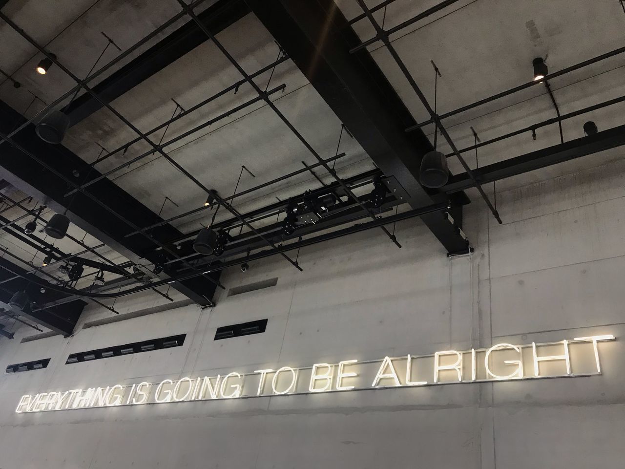 low angle view, architecture, text, communication, built structure, indoors, no people, lighting equipment, illuminated, railroad station, western script, ceiling, information, hanging, sign, wall - building feature, information sign, industry