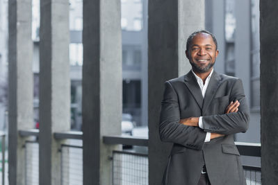 Portrait of businessman standing in city