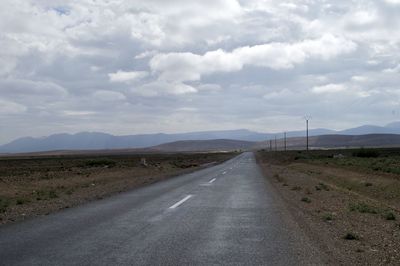 Empty road along countryside landscape