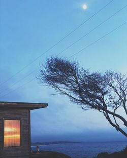 Scenic view of sea by building against sky