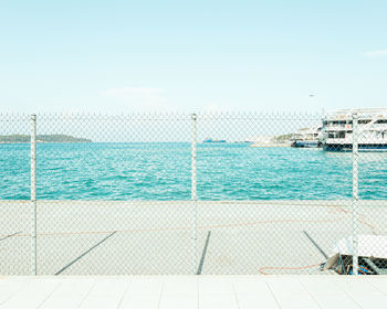 Scenic view of swimming pool by sea against sky