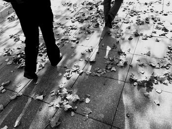 Low section of people standing on tiled floor