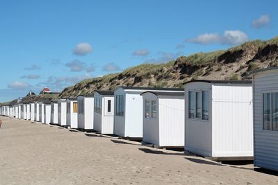 Built structure on beach against blue sky