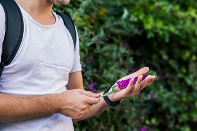 Midsection of woman holding purple outdoors