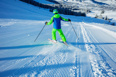 Full length of man skiing on snow covered landscape