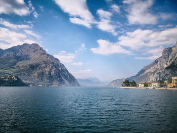 Scenic view of sea and mountains against sky