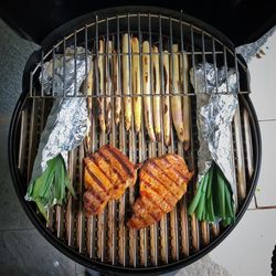 High angle view of meat on barbecue grill