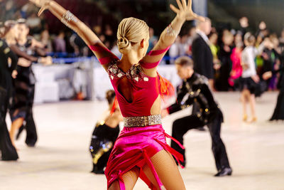 Midsection of woman dancing at music concert