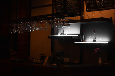 Illuminated bottles on display at restaurant