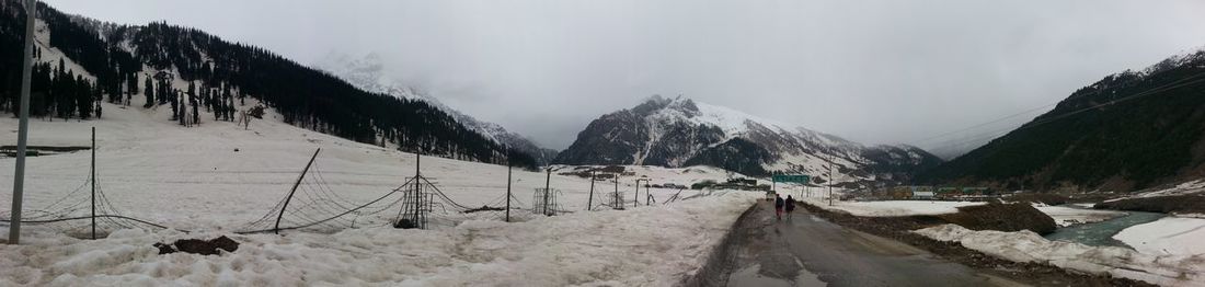 Panoramic view of snow covered mountain against sky