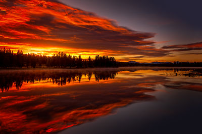 Scenic view of lake against romantic sky at sunset