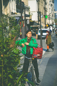 Portrait of man standing on street in city