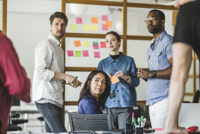 Male and female colleagues working in board room at creative office