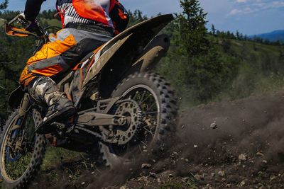 Side view of man riding motorcycle on field