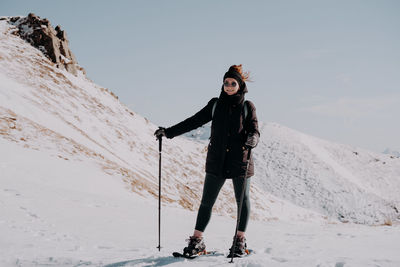 Full length of woman skiing on snow