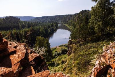 Scenic view of trees and rocks against sky