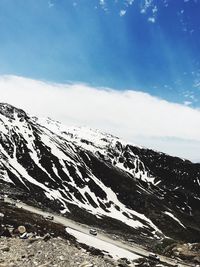 Scenic view of snow covered mountains against sky