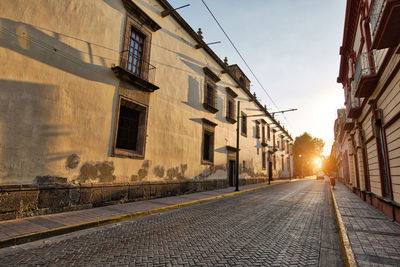 Empty alley amidst buildings in city