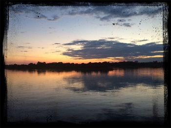 Scenic view of lake at sunset