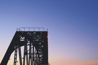 Low angle view of illuminated bridge against clear sky